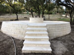 Curved stone patio wall with wide staircase and seating area