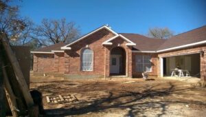 Brick house exterior with arched entryway and masonry facade